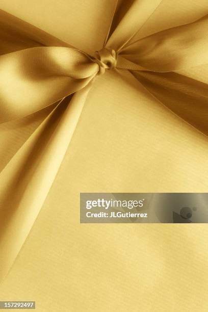 yellow gift box with matching ribbon - gold ribbon stock pictures, royalty-free photos & images