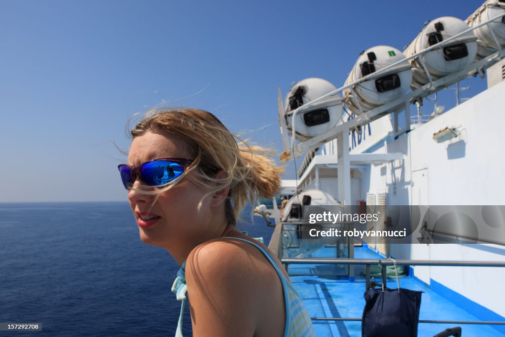 Young girl relaxing on the deck of a cruise ship