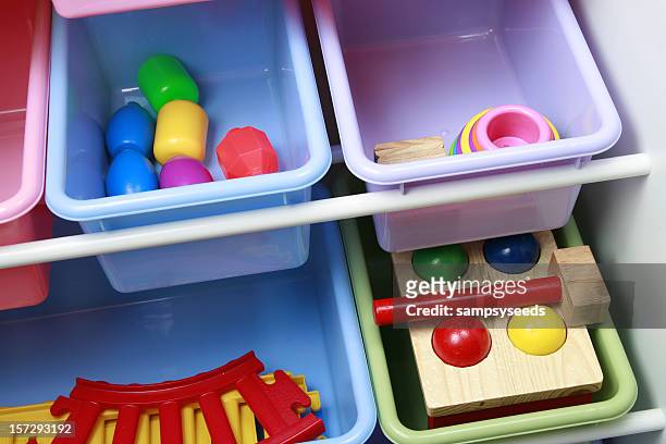 multiple colorful plastic bins used for toy storage - storage stock pictures, royalty-free photos & images