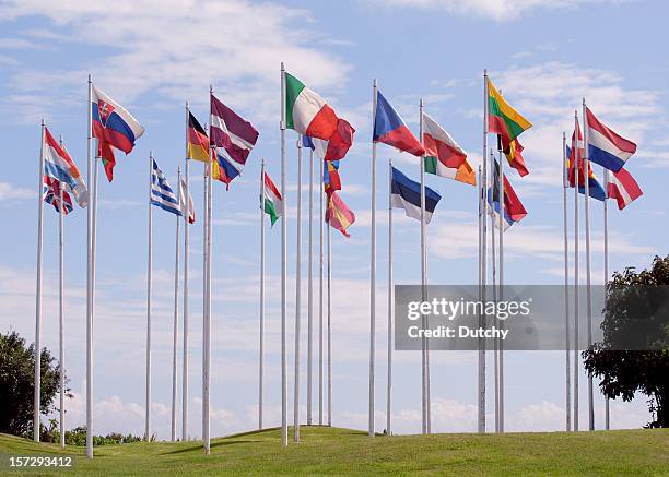 flags of the european union, in a circle, on tall flagpoles - flagpole stock pictures, royalty-free photos & images