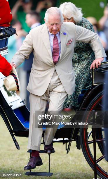 King Charles III and Queen Camilla arrive, in a horse drawn carriage, for a visit to the Sandringham Flower Show on the Sandringham estate on July...