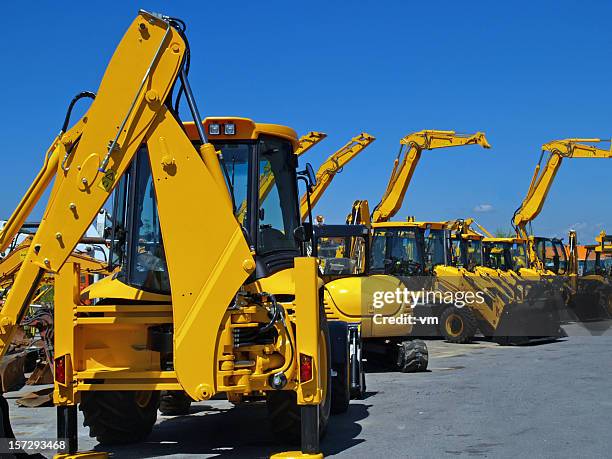 diggers en una fila en industrial estacionamiento - construction equipment fotografías e imágenes de stock