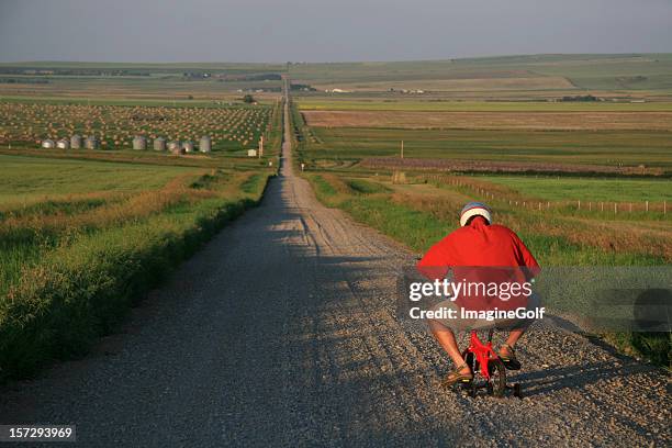 senior man going for a bicycle ride on tiny bike - too small stockfoto's en -beelden