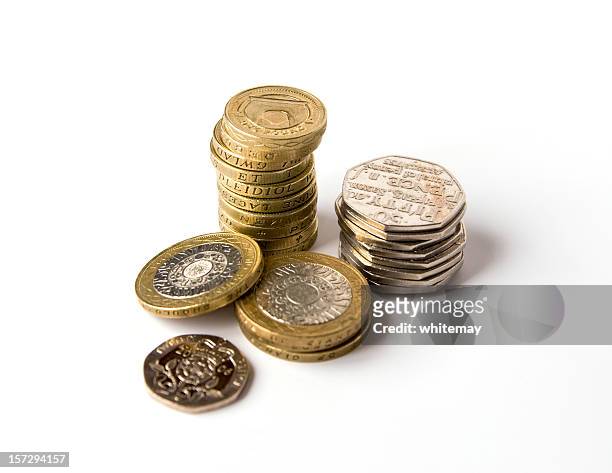 three piles of silver and gold coins - british coin stock pictures, royalty-free photos & images