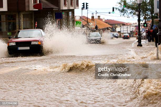 car driving through flood water on a road in bulgaria - skyfall bildbanksfoton och bilder