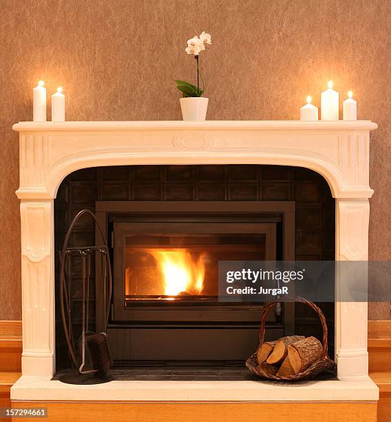 fireplace with burning firewood in the cozy living room - mantel stock pictures, royalty-free photos & images