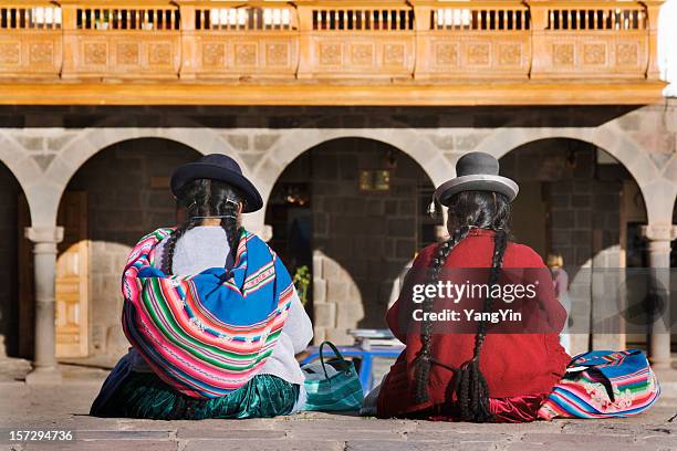 cuzco, peru—indigenous latin american women sitting in traditional clothing - cusco city stock pictures, royalty-free photos & images