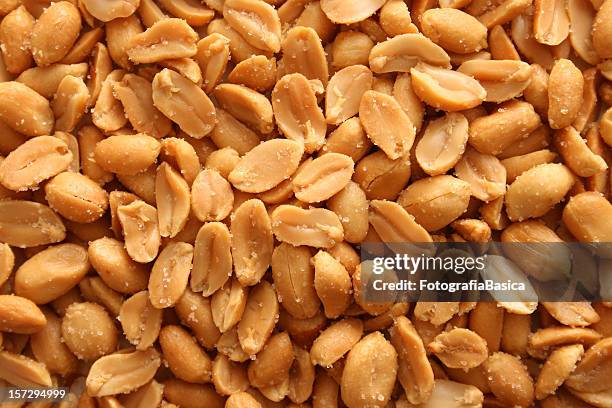 salted peanuts background - peanuts stock pictures, royalty-free photos & images