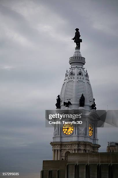clock and william penn on philadelphia's city hall at dusk - william penn stock pictures, royalty-free photos & images