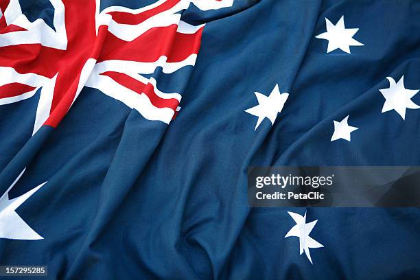 a folded australian flag sitting in hard surface - australia flag stock pictures, royalty-free photos & images