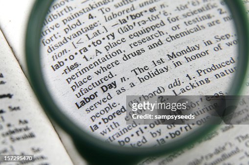 A magnifying glass showing the definition of Labor Day