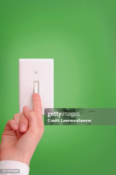 turning on and off the light switch - light switch hand stock pictures, royalty-free photos & images