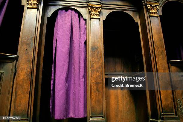 a catholic confession booth with a purple curtain - confession religion stock pictures, royalty-free photos & images