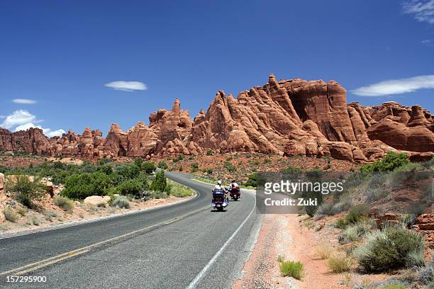 two motorcycles on a tarred road in the desert - utah road stock pictures, royalty-free photos & images
