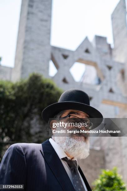 orthodox jewish man under a very large star of david of a synagogue - haredi judaism stock pictures, royalty-free photos & images