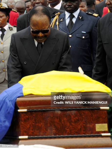 Gabon President Omar Bongo stands at his wife's, Edith Lucie Bongo, coffin on March 19, 2009 at the Presidential Palace in Libreville on March 19,...
