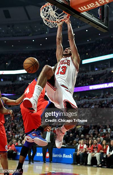 Chicago Bulls center Joakim Noah dunks over Philadelphia 76ers small forward Dorell Wright in the first half at the United Center in Chicago,...