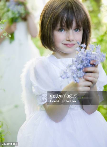 portrait of a young girl in a fairy costume holding flowers - head of state stock pictures, royalty-free photos & images