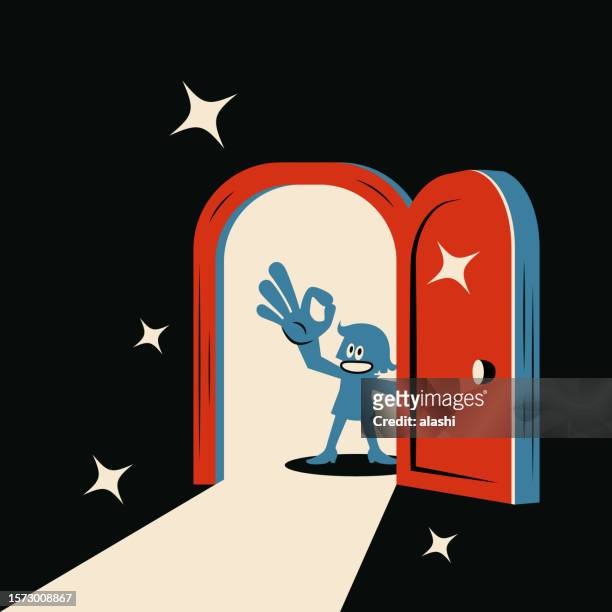a smiling woman opens the door and raises her hand to give an ok gesture, and light shines into the dark room - teenager alter stock illustrations