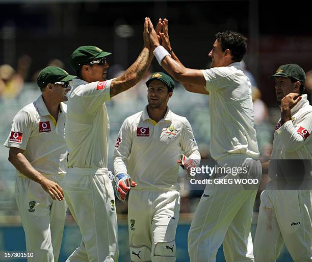 Australian fieldsman Mitchell Johnson and bowler Mitchell Starc congratulate each other after combining to dismiss South African batsman Jacques...