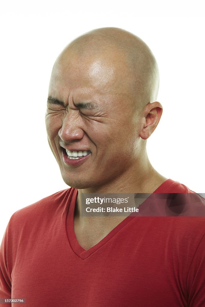 Asian man laughing.