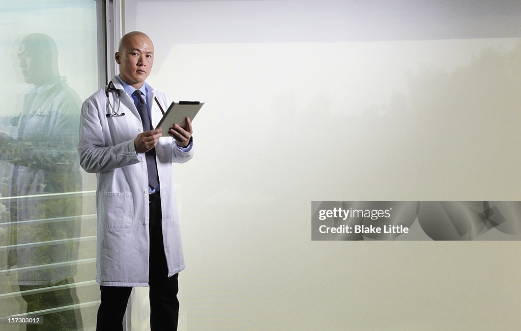 Doctor holding a digital tablet.