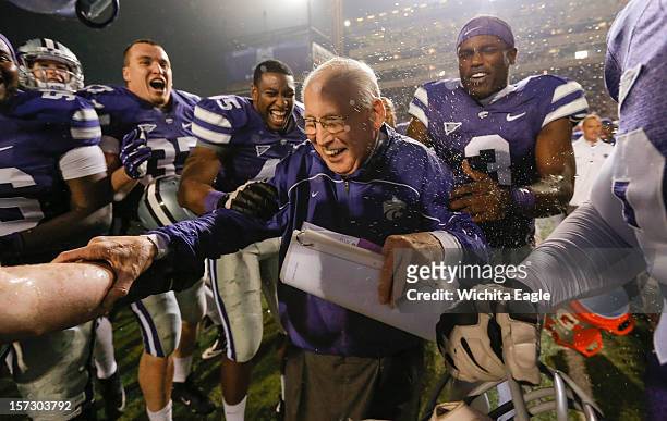 Kansas State head coach Bill Snyder is doused with water by his players after the Wildcats defeated Texas, 42-24, to win the Big 12 title on...