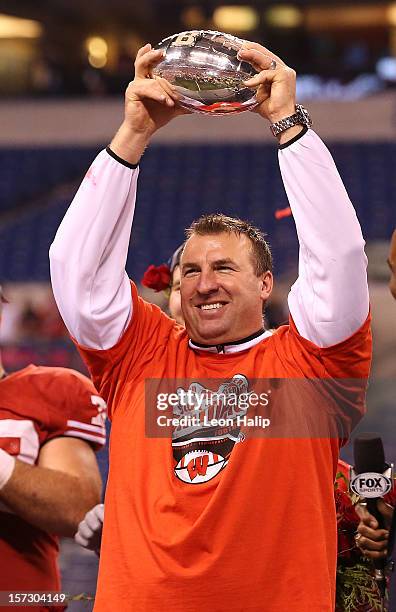 Wisconsin Badgers head coach Bret Bielema celebrates the Big Ten Championship holding the Amos Alonzo Stagg Championship Trophy after defeating the...