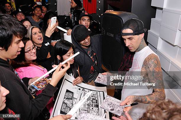 Blink-182 drummer Travis Barker signs autographs for fans at the launching of the One Life One Chance web store on December 1, 2012 in Los Angeles,...