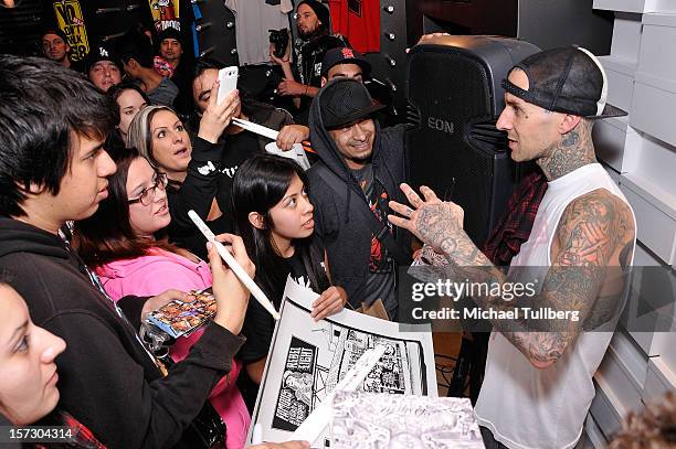 Blink-182 drummer Travis Barker signs autographs for fans at the launching of the One Life One Chance web store on December 1, 2012 in Los Angeles,...