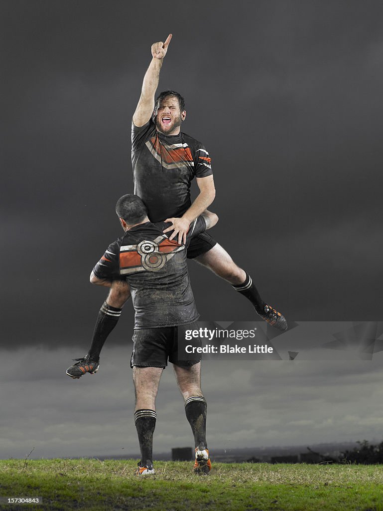 Rugby players celebrating.