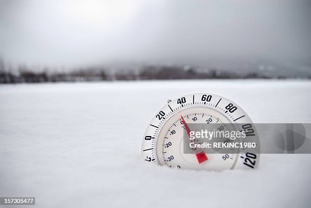 thermometer in desolate winter snow tundra - fahrenheit stock pictures, royalty-free photos & images