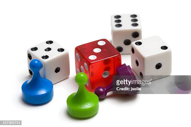 three colored game pieces and four dice on white background - part of stock pictures, royalty-free photos & images