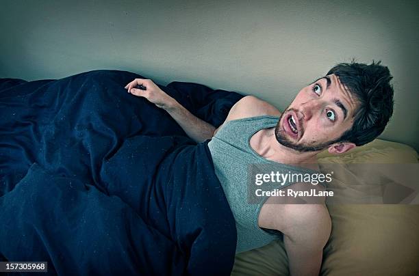 young man wakes up from bad dream - terrified stock pictures, royalty-free photos & images