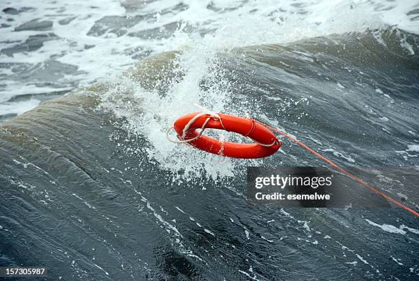 a life preserver being thrown into the water - coast guard stock pictures, royalty-free photos & images