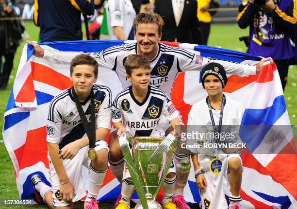 David Beckham poses with his sons Brooklyn , Cruz and Romeo and the MLS Trophy after the Los Angeles Galaxy beat Houston Dynamo 3-1 in the Major...