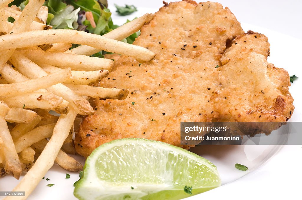 Breaded chicken, salad, and fries