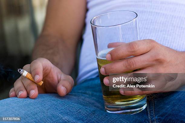 guy with beer and cigarette - alcohol and smoking stock pictures, royalty-free photos & images