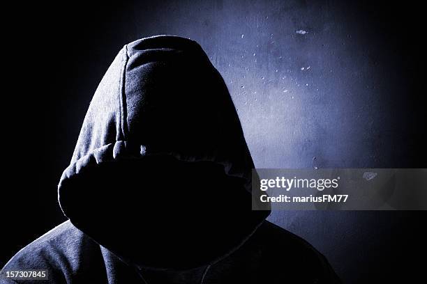 dangerous man in the shadow - villain stock pictures, royalty-free photos & images