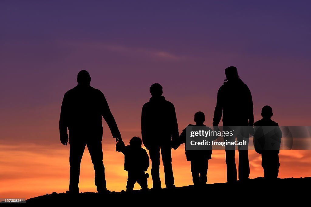 Silhouette of a Multi-Generational Happy Caucasian Family Holding Hands