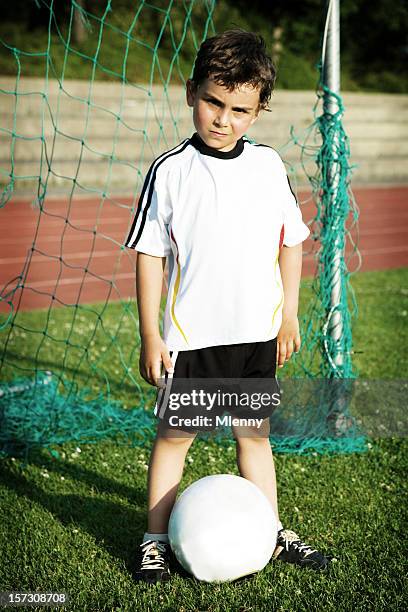 young soccer champion - boy goalie standing in front of goal net stock pictures, royalty-free photos & images
