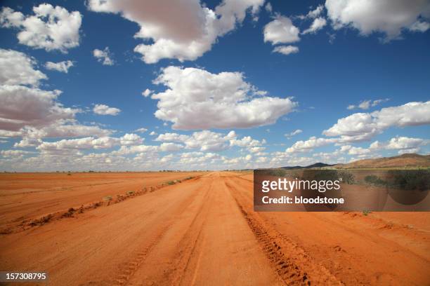 long orange outback road under a blue sky - new south wales landscape stock pictures, royalty-free photos & images