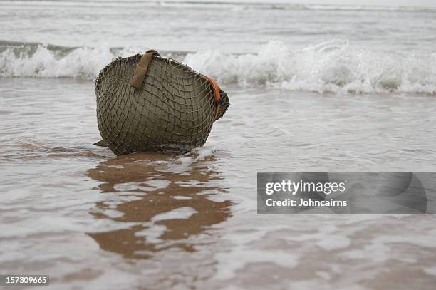 helmet on beach. - d day stock pictures, royalty-free photos & images