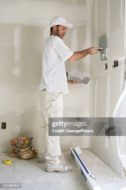 applying mud to sheetrock - applying plaster stock pictures, royalty-free photos & images