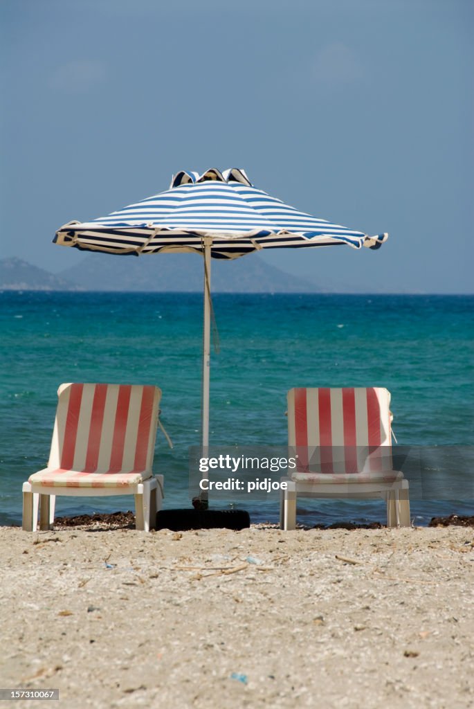 Parasol and two beach chairs