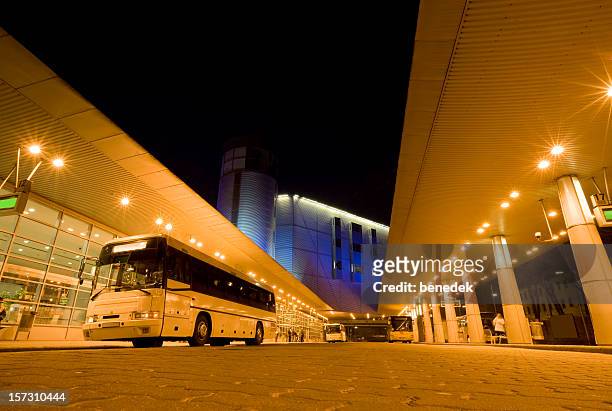 long distance bus station illuminated at night - bus station stock pictures, royalty-free photos & images