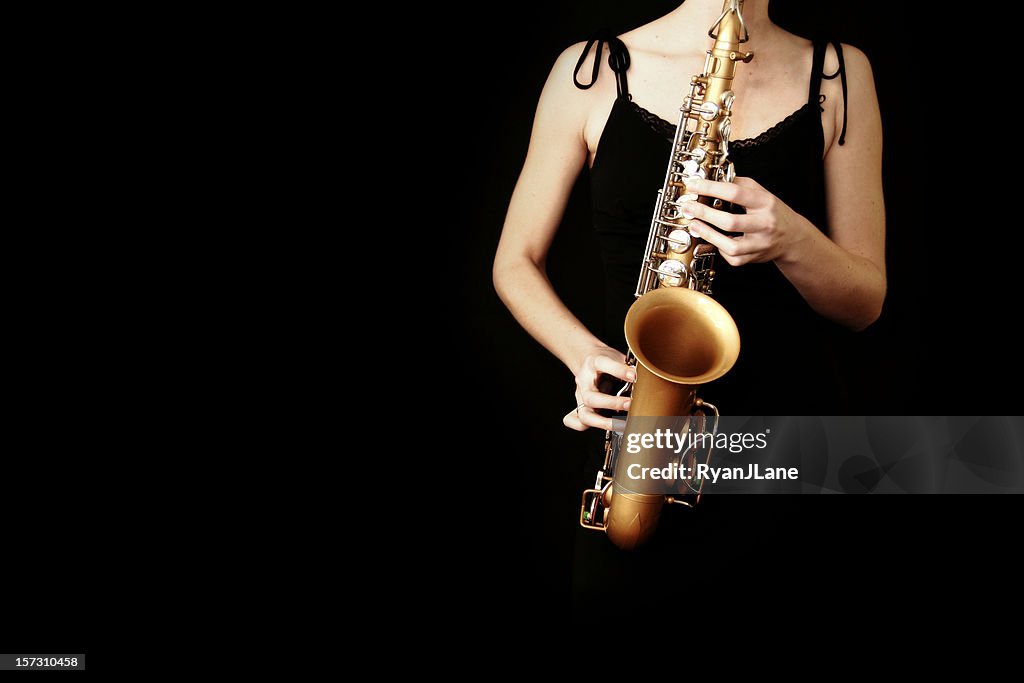 Young Woman Playing Saxophone on Black Background