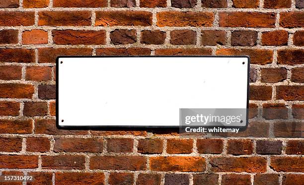 blank sign on red brick wall - name plate stockfoto's en -beelden