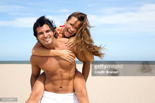 happy summer couple enjoying on the beach - pectoral muscle stockfoto's en -beelden