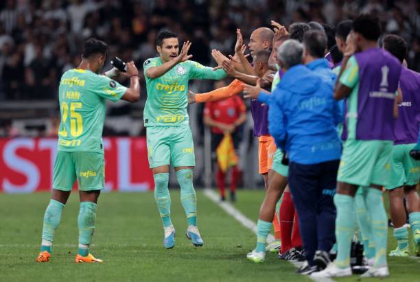 Palmeiras' midfielder Raphael Veiga celebrates with teammates after scoring during the Copa Libertadores round of 16 first leg football match between...
